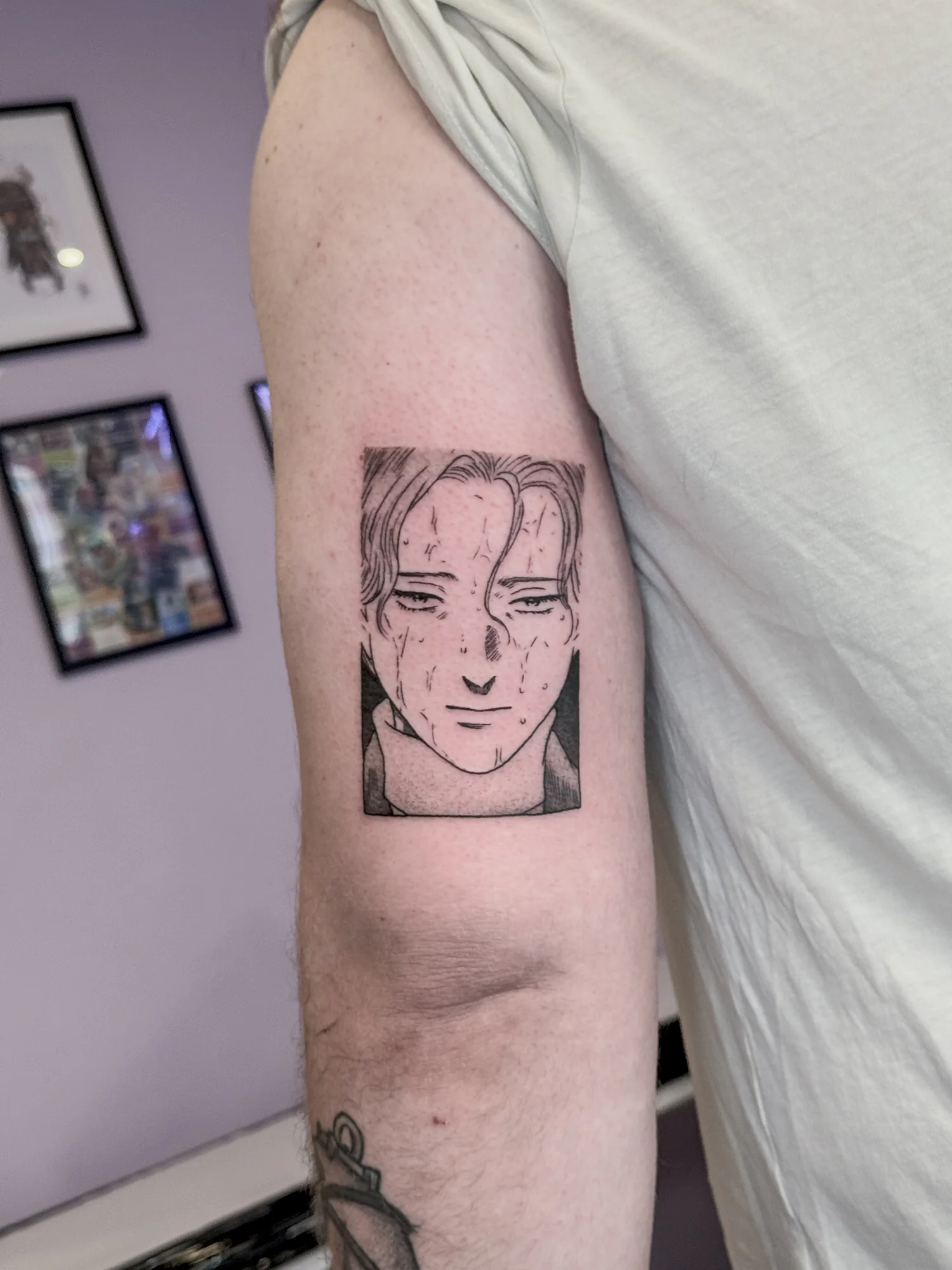 Tatouage blackwork fin de Johan, personnage du manga Monster, inspiré d'une case du manga et réalisé sur le haut du bras au-dessus du coude.